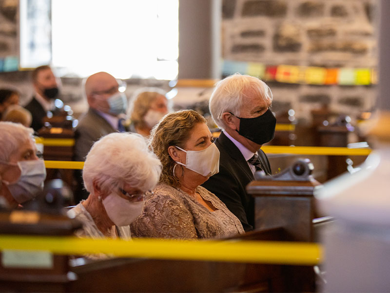 Sea and Silk Events - Ottawa Wedding Planner - COVID wedding 2020 - Elderly relatives in church pews wearing masks at a traditional summer weddingjpg