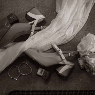 Sea and Silk Events - flat lay of vintage style shoes jewelry and roses